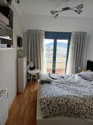 a bedroom with a bed and a large window at Foz te espera in Foz