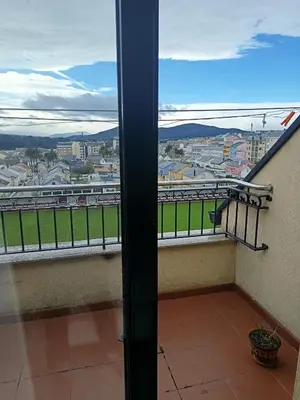 a balcony with a view of a city at Foz te espera in Foz