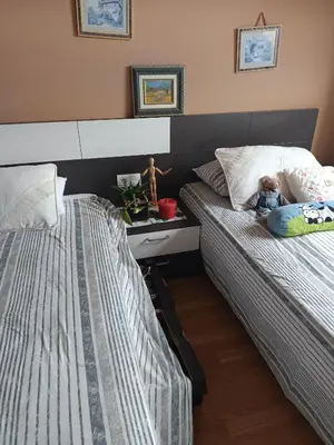 two beds in a bedroom with a baby laying on them at Foz te espera in Foz