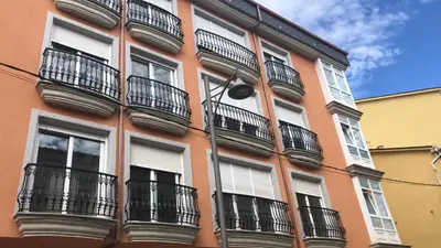 a orange building with balconies and a street light at Aparthotel A&M VIÑA II in Jove