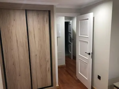 a room with a wooden door and a hallway at Aparthotel A&M VIÑA II in Jove