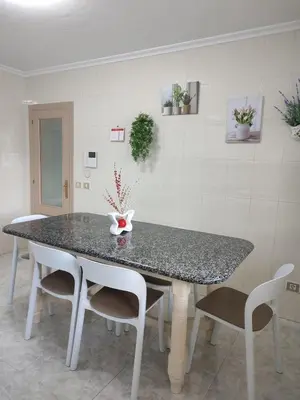 a dining room table with chairs and a counter top at Apartamento vacacional Meira in Meira