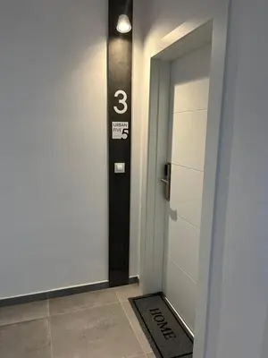 a hallway with a door with the number three on it at Urbanfive apartamentos Ourense centro in Ourense