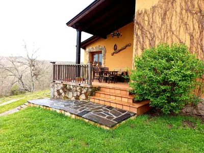 a house with a deck with a table on it at Estrella del alba in Villarino de Sanabria