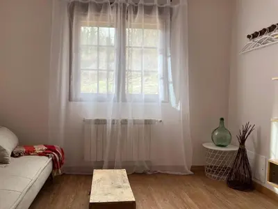 a living room with a couch and a window at Estrella del alba in Villarino de Sanabria