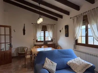 a living room with a blue couch and a table at Estrella del alba in Villarino de Sanabria