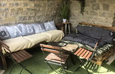 a living room with a couch and a table and chairs at Mirador de Babia in Huergas