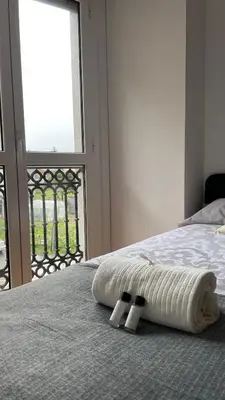 a bedroom with a bed with a towel and a window at Trailhouse CASTELAO in Sarria