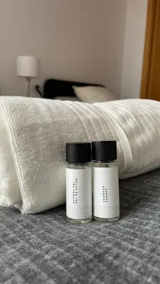 two jars sitting on a bed next to a blanket at Trailhouse CASTELAO in Sarria