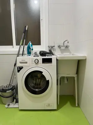 a washing machine in a bathroom next to a sink at Trailhouse CASTELAO in Sarria