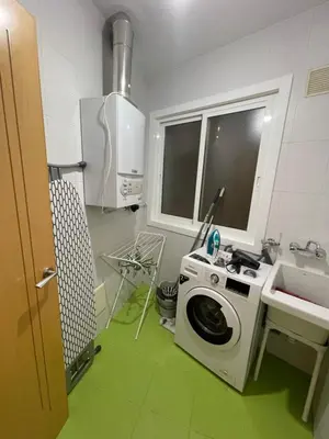 a kitchen with a washing machine and a sink at Trailhouse CASTELAO in Sarria