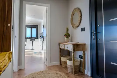 a hallway with a blue door and a wooden table at Casa Areas in Boimorto
