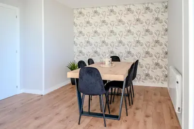 a dining room with a wooden table and chairs at Casa Areas in Boimorto