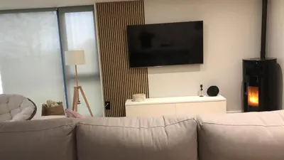 a living room with a couch and a flat screen tv at Casa Areas in Boimorto