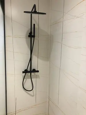 a shower with two shelves on a white wall at Casa Areas in Boimorto