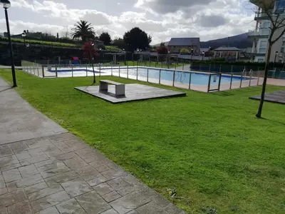 a swimming pool with a bench in a park at Descubre Foz con nosotros in Foz
