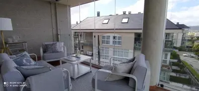 a balcony with couches and a table on a building at Descubre Foz con nosotros in Foz
