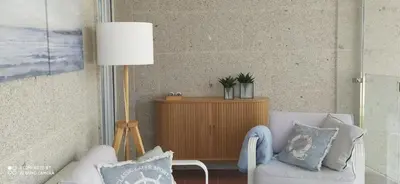 a living room with two chairs and a lamp at Descubre Foz con nosotros in Foz