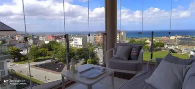 a living room with a view of the ocean at Descubre Foz con nosotros in Foz