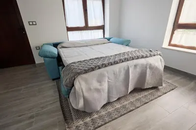 a bedroom with a bed and a rug at Casa Melina in Villapedre