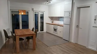 a kitchen with a table and chairs in a room at Floor en Forcarei in Forcarei