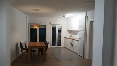 a kitchen with a table and chairs in a room at Floor en Forcarei in Forcarei