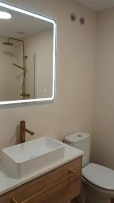 a bathroom with a white sink and a toilet at Floor en Forcarei in Forcarei