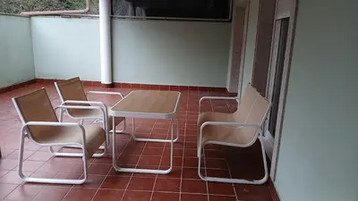 a group of chairs and a table on a patio at Floor en Forcarei in Forcarei