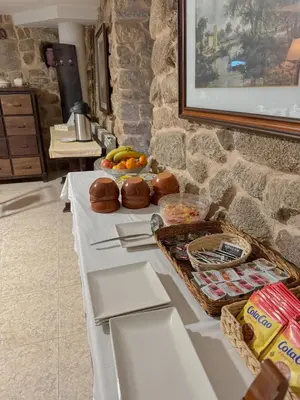 a long white table with food on top of it at Hotel rústico Aldea Figueiredo in Ourense