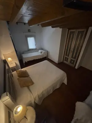 a small bedroom with a bed and a window at Hotel rústico Aldea Figueiredo in Ourense