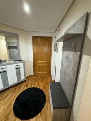 a living room with a couch and a kitchen at Paseo del río in Ponferrada
