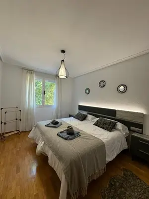 a bedroom with a large bed and a window at Paseo del río in Ponferrada