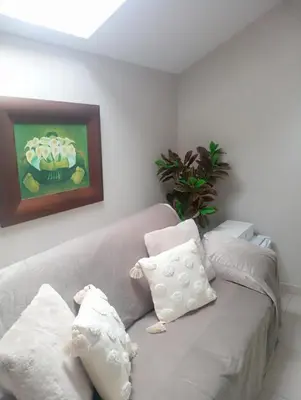 a living room with a gray couch with pillows at El Naranjo in Padrón