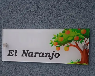 a sign with an apple tree on a wall at El Naranjo in Padrón