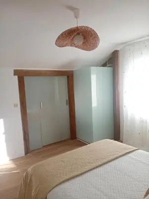 a bedroom with a bed and a pendant light at El Naranjo in Padrón