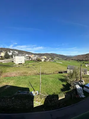 a view of a field with a house in the background at Apartamentos Helenias in Boal