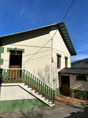 a white building with a staircase next to a door at Apartamentos Helenias in Boal