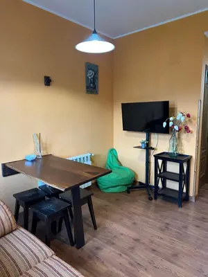 a living room with a wooden table and a tv at Apartamentos Helenias in Boal