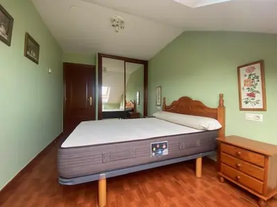 a bedroom with a large bed and a dresser at Monte Faro in Lalín