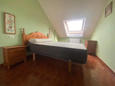 a bedroom with a large bed and a window at Monte Faro in Lalín