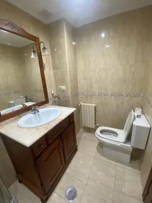 a bathroom with a sink and a toilet and a mirror at Monte Faro in Lalín