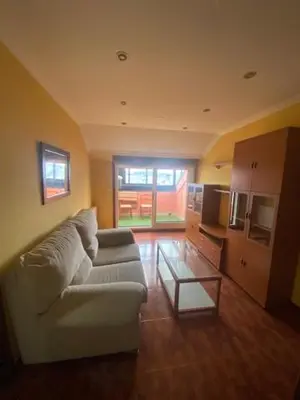 a living room with a couch and a table at Monte Faro in Lalín
