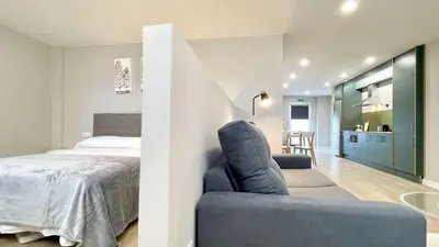 a bedroom with a bed and a chair in a room at The Cliffs - AT Seiramar in Viveiro