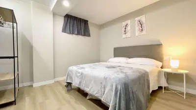 a small bedroom with a bed and a table at The Cliffs - AT Seiramar Sacido in Viveiro