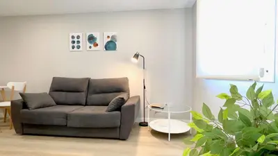 a living room with a couch and a lamp at The Cliffs - AT Seiramar Sacido in Viveiro