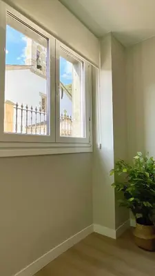 a room with a window and a potted plant at The Cliffs - AT Seiramar Os Castelos in Viveiro