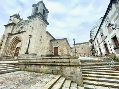 an old stone church with a clock tower and stairs at The Cliffs - AT Seiramar Area in Viveiro