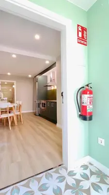 a kitchen and dining room with a fire extinguisher on the door at The Cliffs - AT Seiramar Area in Viveiro