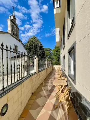 a row of benches sitting on the side of a building at The Cliffs - AT Seiramar Area in Viveiro