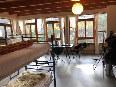 a bedroom with a bed and a table and chairs at Casa Cantadora in Ambasmestas